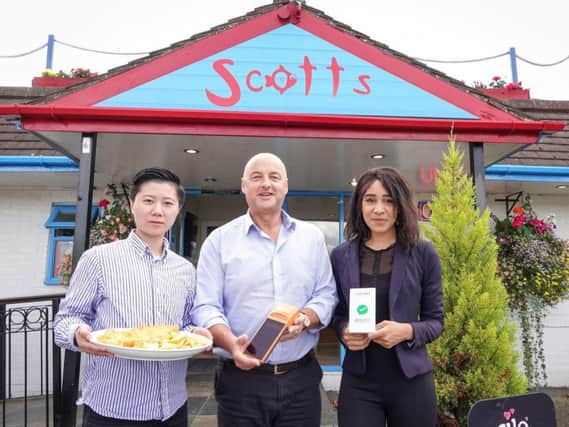 Tony Webster, owner of Scotts fish and chip shop (centre) near York, with JGOO's head of operations Xiaowen Li (left) and senior sales executive Nafisa Meme (right). Picture by Scotts Fish and Chips/PA Wire.