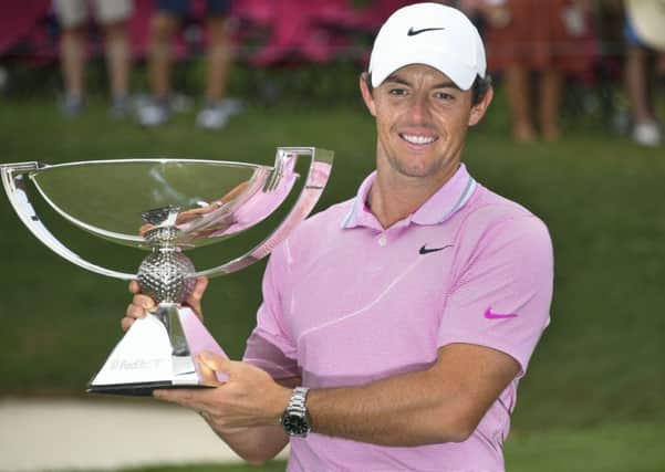 Winner: Rory McIlroy holds up the FedEx Cup trophy. Picture: AP Photo/John Amis