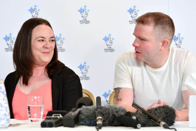 Vicky Mitchell and her partner Adam discussing her lottery win at the Holdsworth Hotel in Halifax. Picture by Anthony Devlin.
