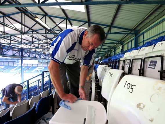 A Bury supporter pictured at the clean-up at Gigg Lane.
