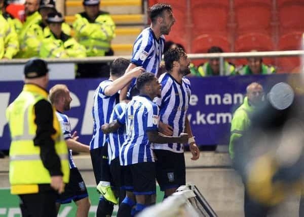 Atdhe Nuhiu is mobbed by team-mates after scoring the winning goal against Rotherham (Picture: Steve Ellis)