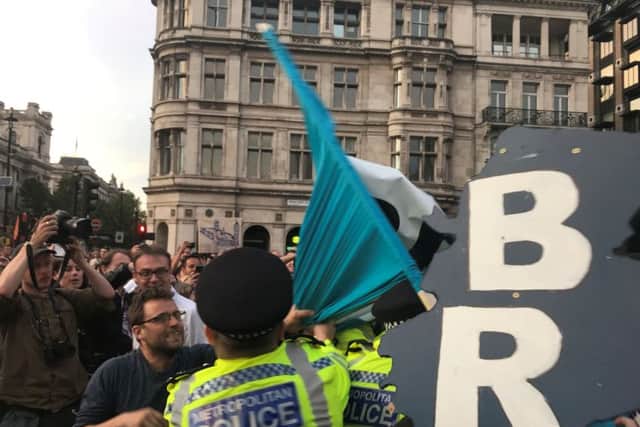 Anti-Brexit protesters clash with police outside Parliament.