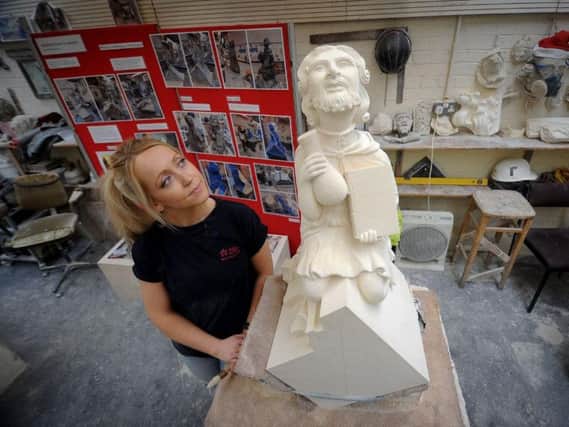 Harriet with the grotesque - which was modelled on her father Picture: Simon Hulme