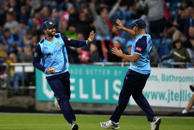 Yorkshire's Will Fraine celebrates with Tim Bresnan, after catching Northamptonshire's Dwaine Pretorius, off the bowling of David Willey. Picture Jonathan Gawthorpe