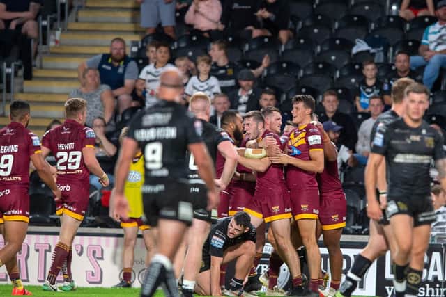 Huddersfield Giants' Louis Senior (far right) celebrates his match-winning try (PIC: BRUCE ROLLINSON)