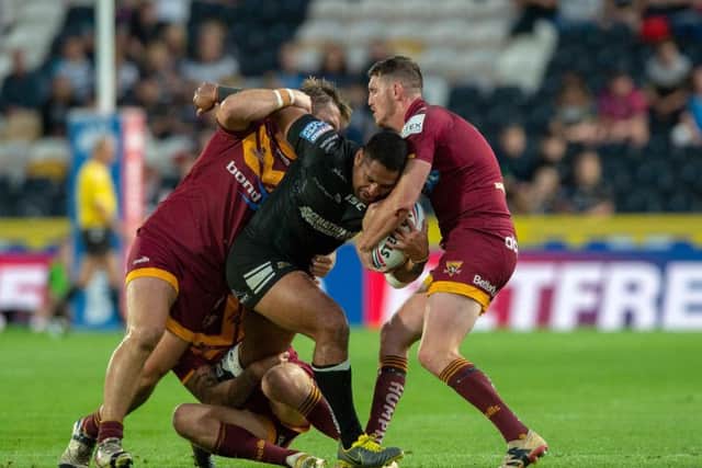 Hull FC's Mickey Paea is all wrapped up by Huddersfield's defence. (PIC: BRUCE ROLLINSON)