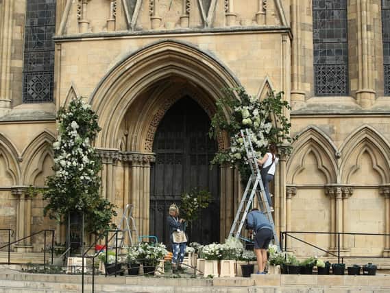 Florists prepare displays at the entrance to York Minster today