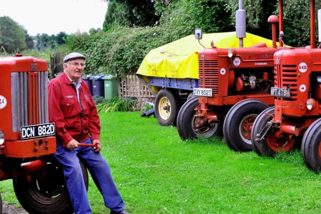 David Robinson sat amongst some of his vintage tractors that  he will be taking to  the  Hunton Steam Gathering.