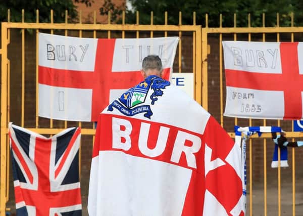 End of the line: A Bury fan at the gates of Gigg Lane.