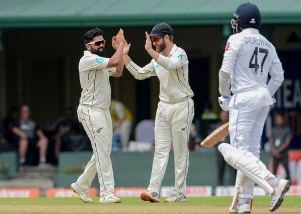 New Zealand's Ajaz Patel, left, is congratulated by captain Kane Williamson after dismissing Sri Lanka's Dilruwan Perera during last month's Test match in Colombo. Picture: LAKRUWAN WANNIARACHCHI/AFP/Getty Images)