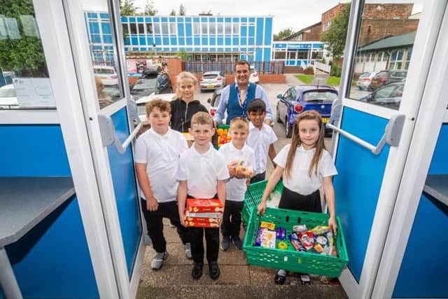 Parklands Primary School headteacher Chris Dyson and pupils with some of the items.