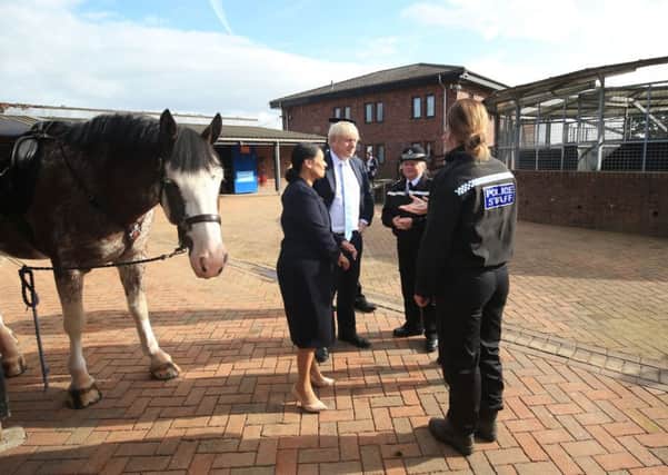 Boris Johnson and Priti Patel, the Home Secretary, during a visit to West Yorkshire Police's headquarters in Wakefield.