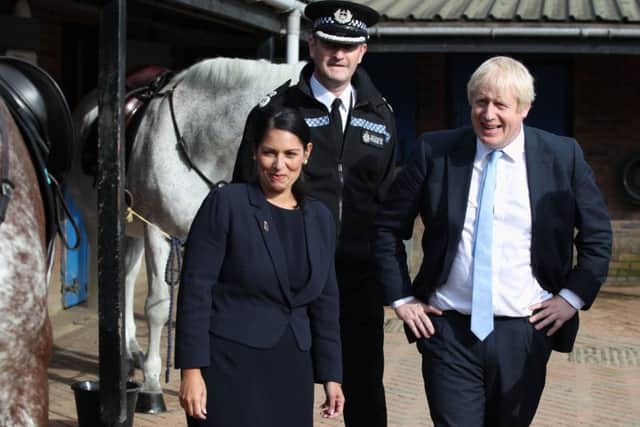 Prime Minister Boris Johnson and Home Secretary Priti Patel during a visit to West Yorkshire Police.