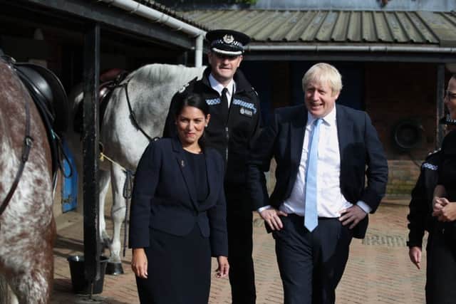 Home Secretary Priti Patel (left) and Boris Johnson (right) during their visit to West Yorkshire Police - will they cut crime and deliver Brexit?