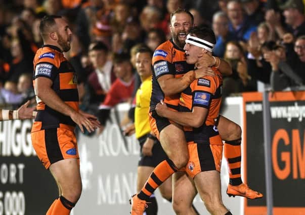 Castleford Tigers' Jake Trueman is congratulated on his hat trick try by Paul McShane. (Picture: Jonathan Gawthorpe)