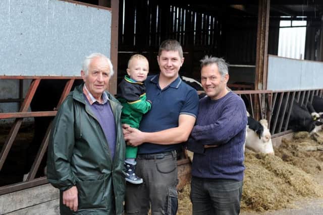 Sam Raynes with his son Matthew, his granddad Burton Rusby, left, and his uncle James Rusby, right, at Carr Lane Farm near Penistone. Picture by Tony Johnson.