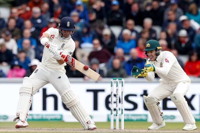 England's Rory Burns cuts through the off side off Nathan Lyon at Old Trafford. Picture: Martin Rickett/PA