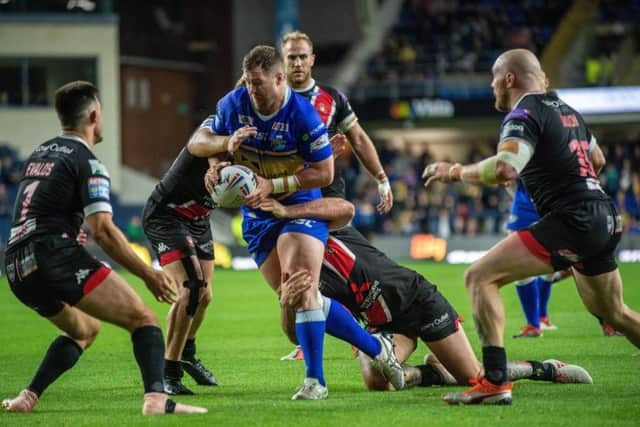 PUSHING HARD: Leeds Rhinos' Trent Merrin pushes for the line against Salford Red Devils at Headingley.
 Picture: Bruce Rollinson