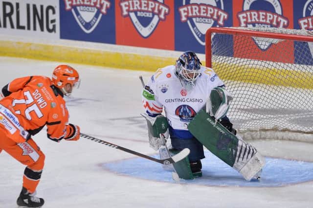 GET IN: Robert Dowd fires past Jamie Phillips to make it 1-0 to Sheffield Steelers. Picture: Dean Woolley.