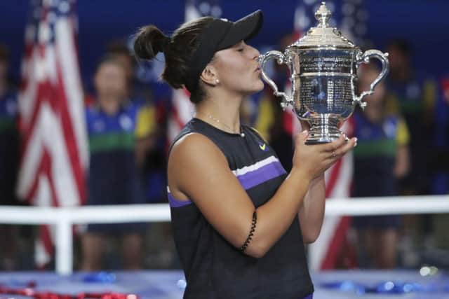 DREAM WIN: Canada's Bianca Andreescu kisses the US Open championship trophy after defeating Serena Williams in Saturday night's final at Flushing Meadow. Picture: AP/Charles Krupa.