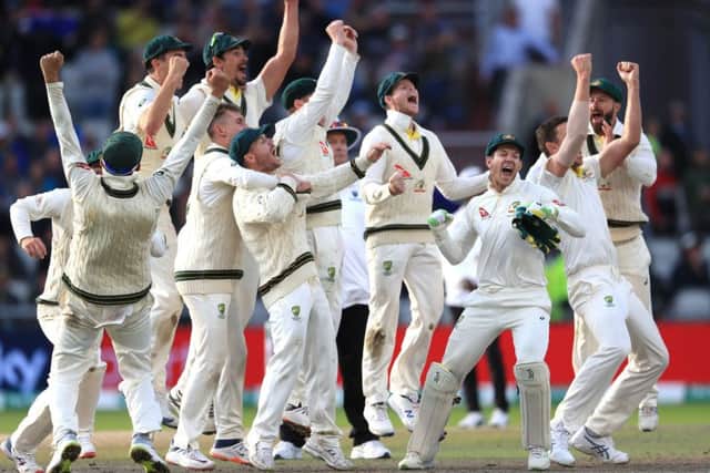 Australia celebrate after they claimed victory to retain the Ashes at Old Trafford.