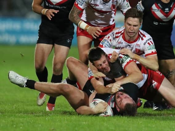 Hull KR's Joel Tomkins on top of London Broncos' Rob Butler during a number of feisty flashpoints in Friday's game. (PIC: Allan McKenzie/SWpix.com)