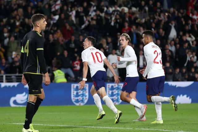 England's Phil Foden (centre) celebrates scoring his side's second goal.