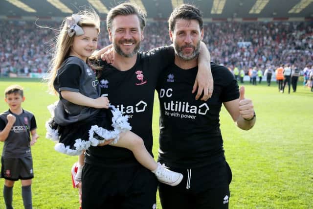 Lincoln City manager Danny Cowley, right, and assistant Nick Cowley celebrate winning the League Two title at Sincil Bank. Picture: Richard Sellers/PA