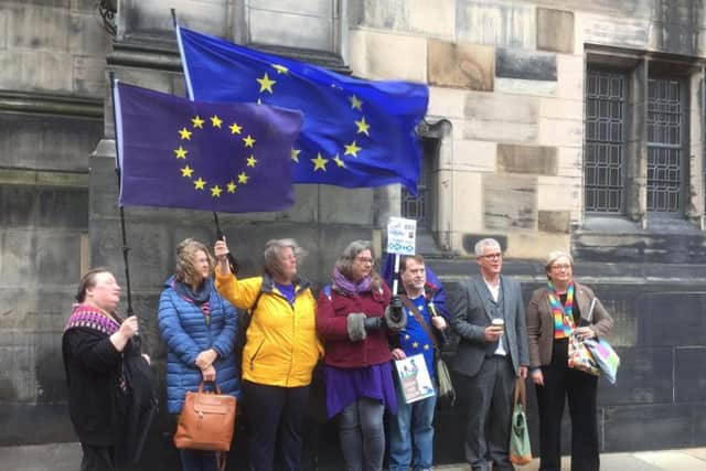 SNP MP Joanna cherry (right), alongside Jo Maugham QC, with campaigners outside Court of Session in Edinburgh, after the legal bid to challenge the suspension of parliament has succeeded and ruled Prime Minister Boris Johnson's prorogation unlawful. Photo: Lucinda Cameron/PA Wire