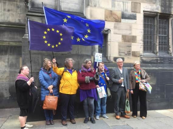 SNP MP Joanna cherry (right), alongside Jo Maugham QC, with campaigners outside Court of Session in Edinburgh, after the legal bid to challenge the suspension of parliament has succeeded and ruled Prime Minister Boris Johnson's prorogation unlawful. Photo: Lucinda Cameron/PA Wire