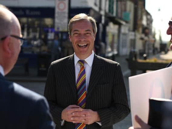 Brexit Party leader Nigel Farage speaks to members of the public during a 'walkabout' campaigning for the European Parliament election in Pontefract. Photo: OLI SCARFF/AFP/Getty Images