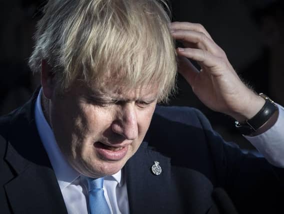 Britain's Prime Minister Boris Johnson reacts during a visit with the police in West Yorkshire. Photo: DANNY LAWSON/AFP/Getty Images