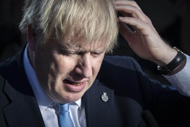 Britain's Prime Minister Boris Johnson reacts during a visit with the police in West Yorkshire. Photo: DANNY LAWSON/AFP/Getty Images