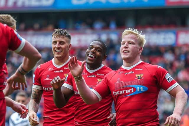 Huddersfield's Jermaine McGillvary celebrates his try against Hull FC at Magic Weekend with team-mates. Picture: Alex Whitehead/SWpix.com