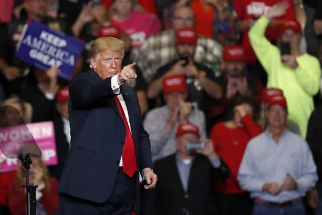 President Donald Trump points to the crowd as he leaves the stage at the end of a campaign rally Monday, Nov. 5, 2018. (AP Photo/Jeff Roberson)
