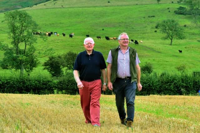 John (left) President of Stokesley Show and Tom Seymour his son walking on Dromonby Farm at Kirkby in Cleveland in the shadow of the Cleveland Hills. Image: Gary Longbottom