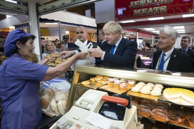 British Prime Minister Boris Johnson shops at a bakery during a visit to Doncaster Market. Photo: Jon Super - WPA Pool/Getty Images