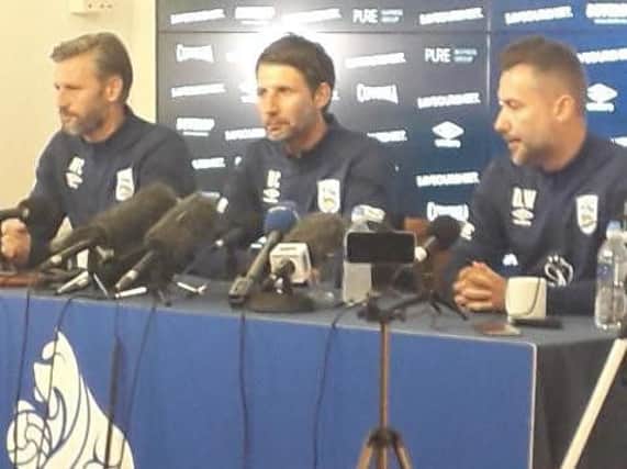 Huddersfield Town manager Danny Cowley (centre) flanked by assistant Nicky Cowley (left) and director of football operations David Webb (right).
