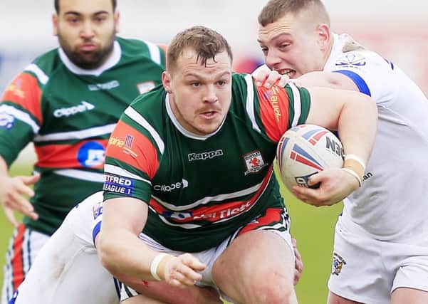 Hunslet's  Tom Ashton tackled by Worlington's Sean Penkywiecz and  Tom Curwen