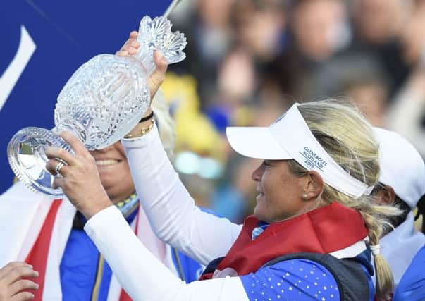 Suzann Pettersen holds the Solheim Cup.