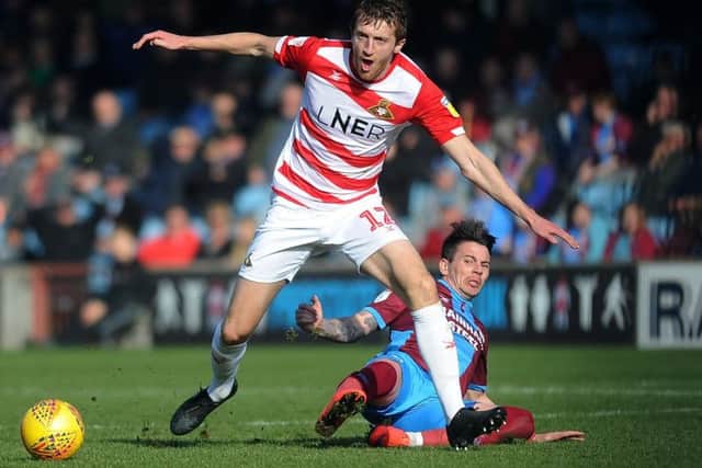 NO WAY THROUGH: Doncaster Rovers' Tom Anderson takes on Scunthorpe's Adam Hammill. Picture: Jonathan Gawthorpe