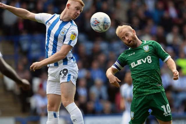 In top form: Owls' Barry Bannan, right, comes up against Huddersfield's Lewis O'Brien.