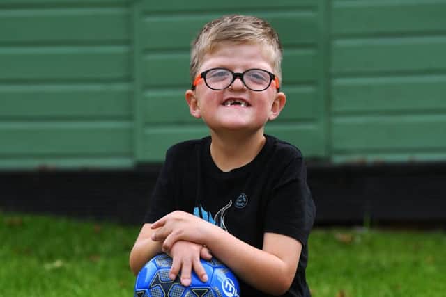 Five-year-old Lewis Connett has had 16 operations after being disganosed with Apert Syndrome  but he still loves football and being outdoors. .
Picture Jonathan Gawthorpe