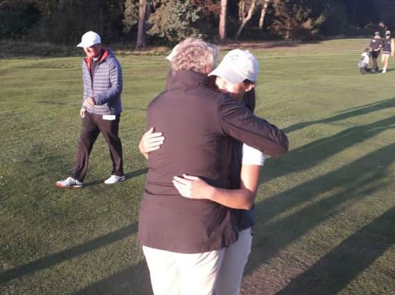 Grateful Yorkshire team captain Heather Muir hugs Melissa Wood after the 5-4 win over Norfolk (Picture: England Golf).