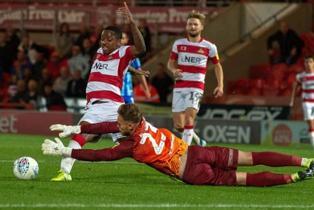 Niall Ennis chases the ball after being denied by Jak Alnwick as Doncaster lost to Blackpool. 
(Picture: Bruce Rollinson)