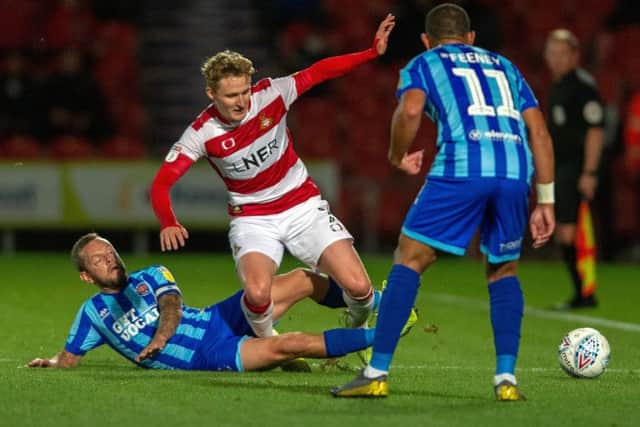 Jay Spearing takes out Kieran Sadlier of 
Doncaster Rovers (Picture: Bruce Rollinson)