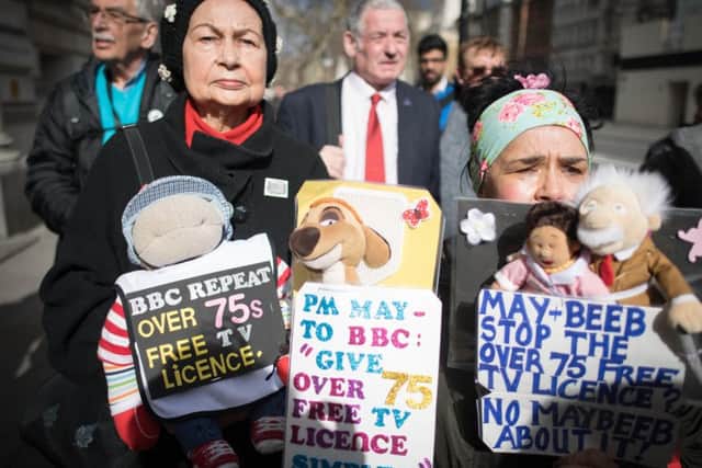 Members of the National Pensioners Convention (NPC) protest in Westminster at the government's decision to pass responsibility for funding the TV licence for over-75s onto the BBC.