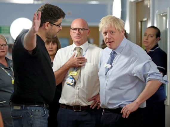 Omar Salem confronts Boris Johnson at a hospital in London. Picture: PA
