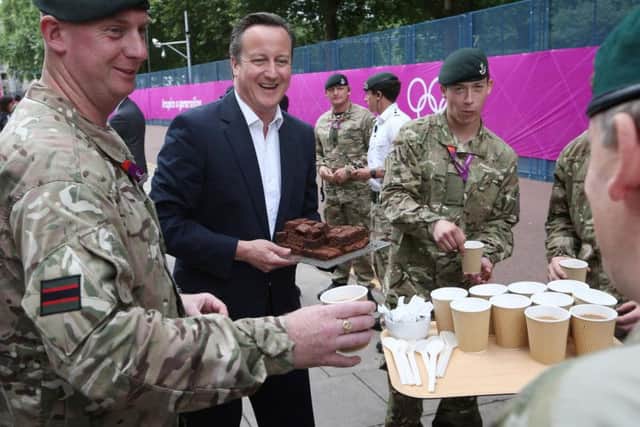 David Cameron hands out brownies to soldiers during the 2012 Olympics. Picture: PA