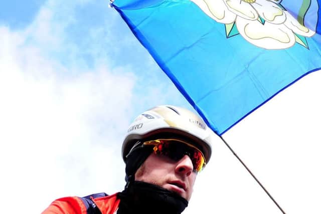 On course:

Bradley Wiggins and a Yorkshire flag before the start of the Beverley to Settle leg of the Tour de Yorkshire